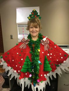 a woman is dressed up in an ugly christmas ponchy with trees on it