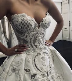 a woman in a wedding dress is posing for the camera