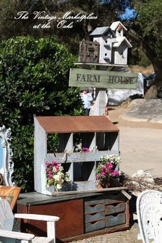 an old dresser is decorated with flowers and birdhouses for the homeownership