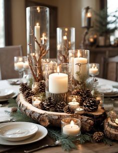 a table topped with lots of candles and pine cones