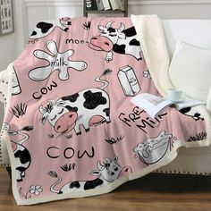 a pink blanket with black and white farm animals on it that says, mom cow