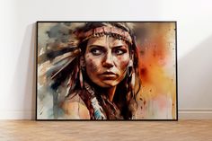 a painting of a native american woman with feathers on her head is hanging in an empty room