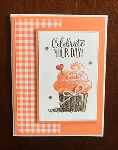 an orange and white card that says celebrate your day with a cupcake on it