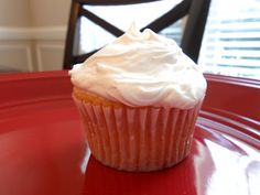 a cupcake sitting on top of a red plate