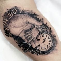 a man with a tattoo on his arm holding the hand of another person that is holding an alarm clock