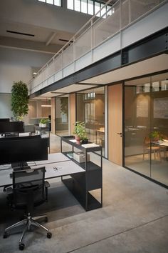 an office building with glass walls and desks