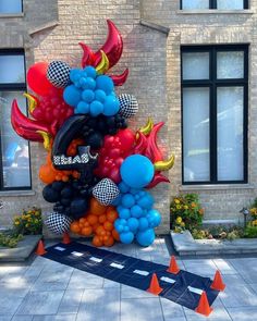 a large balloon sculpture in the shape of a dragon is on display outside an apartment building