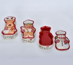 three small dishes and one large bowl are decorated with snowmen, reindeers, and bears