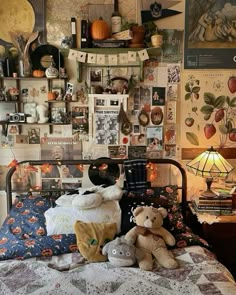 there is a bed with many pictures on the wall above it and two teddy bears