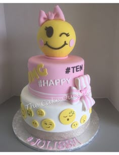 a three tiered cake decorated with smiley faces