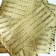 a pile of gold tickets with black dots on them