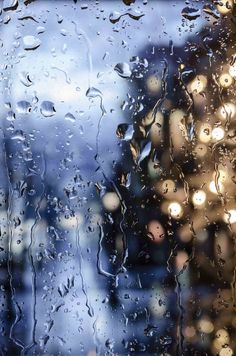 rain drops on the window with buildings in the background