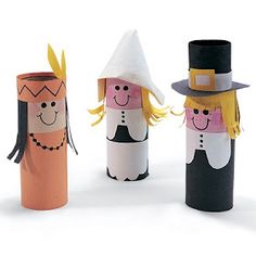 three toilet paper roll dolls with faces and hats on them, one is wearing a top hat