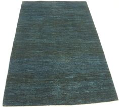 a blue area rug on a white surface with no one around it or someone else