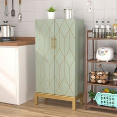 a green cabinet sitting in the middle of a kitchen next to a white refrigerator freezer