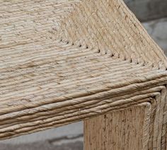 a close up view of a table made out of wicker and wood with no one sitting on it