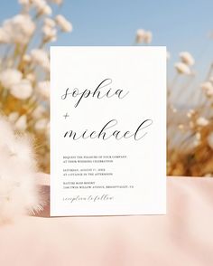 a wedding card with the word sepia and michele on it next to some white flowers