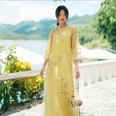 This is an embroidery flower top ao dai with button on the size. Loose form ( ao dai Dang Suong).  SET  1 TOP/ 1 PANT MATERIAL: SILK  (TO LOT LUA). 0/10 stretch SET: Modern ( means the length of ao dai is shorter than traditional ao dai).  Model :  Female model is 5'2 ,wear size S. This fabric is NO STRETCHY so pls take a look a size chart before placing order or inbox us a question bc we DO NOT ACCEPT RETURN or EXCHANGED. Please contact us within 3 days of receiving your order if the merchandise damages. FB: kvshop in usa Vietnamese Ao Dai, Flower Top, Mid Autumn Festival, Traditional Modern, Flower Tops, Silk Pants, Female Model, Tall Women, Orlando Fl