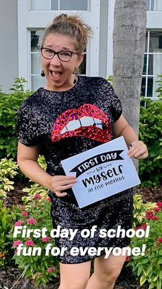 a woman holding a sign that says first day of school fun to everyone