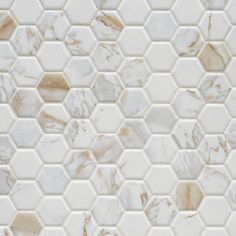 white marble hexagon tiles with gold veining on the backsplashes