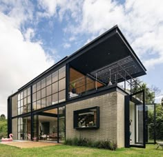 a modern house with large windows on the roof