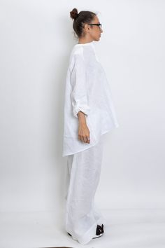 The White linen blouse women is our favorite weekender. Featuring an oversized relaxed fit with front button closing and long sleeves. The long sleeve shirt is made from lightweight linen, that is versatile for any occasion! The White linen blouse women is designed to be comfortable and not troublesome to wear. After wearing this White long sleeve linen shirt women, you will love it even more. ▸FABRIC The white linen blouse women is made from high quality 100% linen ▸SIZING This model linen shir Casual Long Sleeve Tops With Set-in Sleeves, Summer Cotton Blouse With Set-in Sleeves, Oversized Spring Tunic For Loungewear, Effortless Long Sleeve Cotton Blouse, Casual Long Sleeve Blouse With Set-in Sleeves, Spring Blouse With Button Cuffs And Relaxed Fit, Spring White Baggy Top, White Long Sleeve Effortless Top, Effortless White Long Sleeve Top