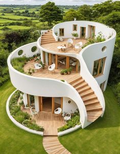 an aerial view of a circular home with stairs leading up to the upper floor and second story