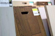 several wooden boxes are stacked on top of each other in a storage area at a furniture store