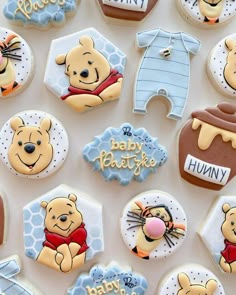 winnie the pooh cookies are decorated with royal icing and fondant for baby's first birthday