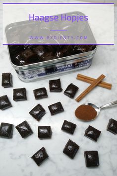 chocolate squares and cinnamon sticks in a tin on a marble counter with text overlay