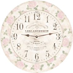 a white clock with pink flowers on it's face and numbers in the middle