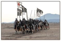 a group of men on horses holding flags