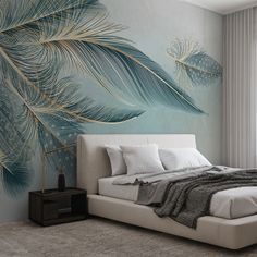 a bed with pillows and blankets on it in front of a wall mural that has blue feathers