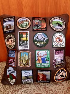 a brown pillow with many different patches on it