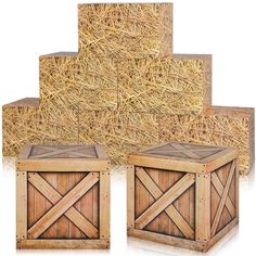 three wooden boxes with hay stacked on top of each other in front of a pile of straw