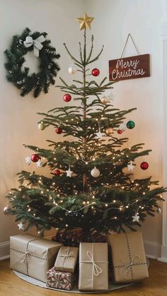 a small christmas tree with presents under it