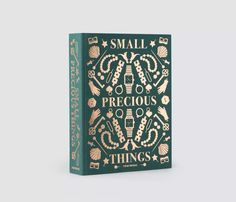 a small book with gold lettering on the front and green cover that says, small precious things