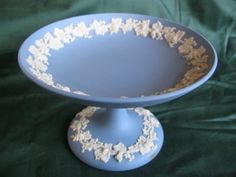 a blue and white cake plate on a green cloth