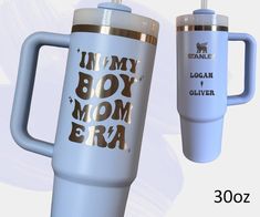 two travel mugs with the words in my boy mom era on them