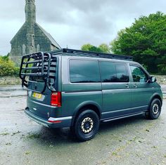 a grey van parked in front of a church