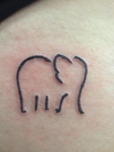 an elephant tattoo on the back of a woman's left shoulder, with lines drawn across it