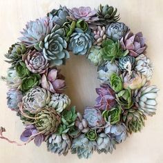 a wreath made out of succulents sitting on top of a table