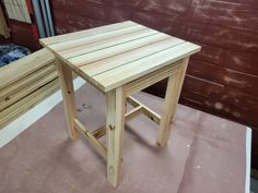 a small wooden table sitting on top of a piece of plywood