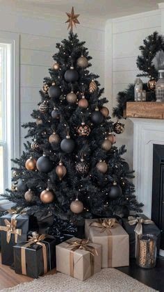 a black christmas tree with gold and silver ornaments is in the corner of a living room