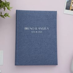 a blue wedding guest book sitting on top of a desk