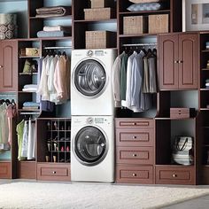 a washer and dryer in a closet with clothes on the shelves next to it