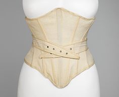 a mannequin wearing a beige corset