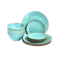 a set of blue dishes with gold rims