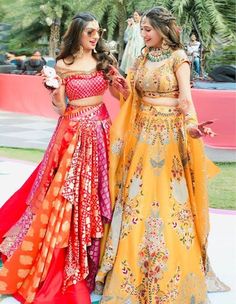 two women in colorful dresses standing next to each other