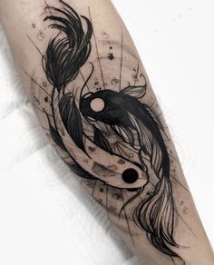 a black and white photo of a tattoo on someone's arm with a koi fish